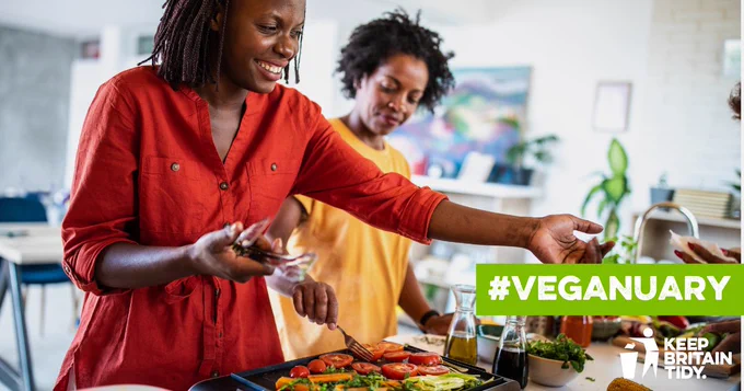 photo of women smiling cooking a vegan meal