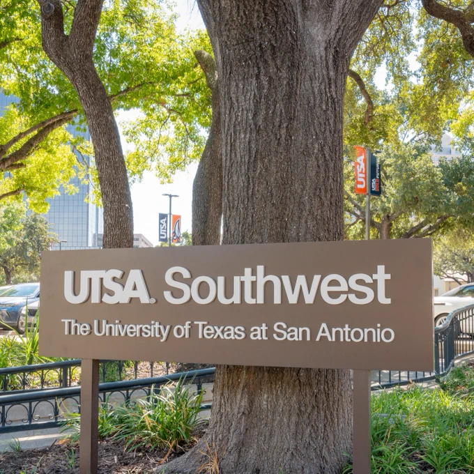 Sign at the UTSA Southwest Campus, surrounded by trees.