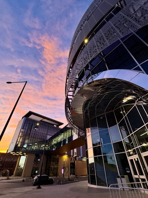 The CSU Spur Hydro and Terra  building with a large picturesque sunset in the background
