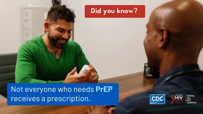 A healthcare provider talks to a patient holding a prescription bottle in their hands.