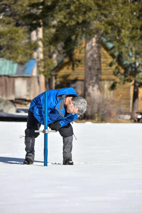 DWR staff conducting the first snow survey of the season at Phillips Station. Photo taken January 2, 2025.