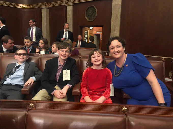 Rep. Porter and her three kids on the House floor on her first day of Congress.