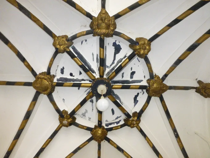 The ribs and bosses of the elegant vaulted ceiling in the north porch have been picked out in black and gold. The bosses show four faces and eight foliage designs.