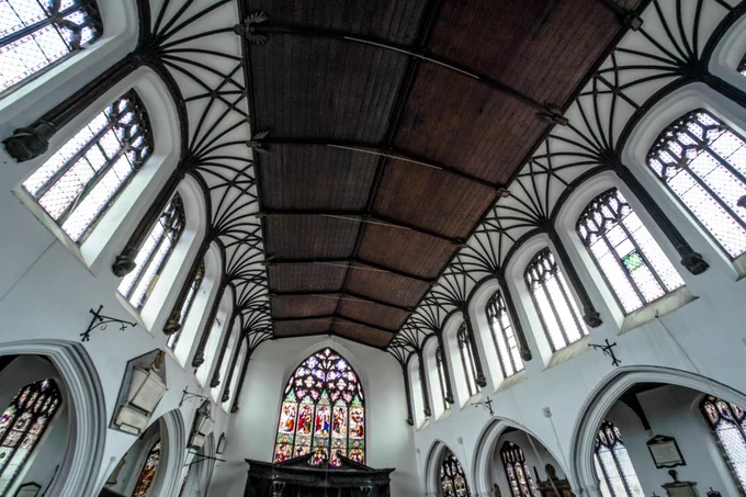 The roof is supported by tall wooden wall-posts, resting upon shield-bearing angel corbels. Wooden arches frame the clerestory windows, which indeed provide a ‘clear-story’ and flood the church with light, and from the tops of the wall-posts ribs splay out to form delicate plaster vaulting, with little foliage bosses. This vaulted coving may well indicate a roof of similar construction to that at St Peter Mancroft, where it covers hammerbeams. The central area is now lined with 19th-century boarding, the original roof above it having been replaced. Image (c) Joseph Casey
