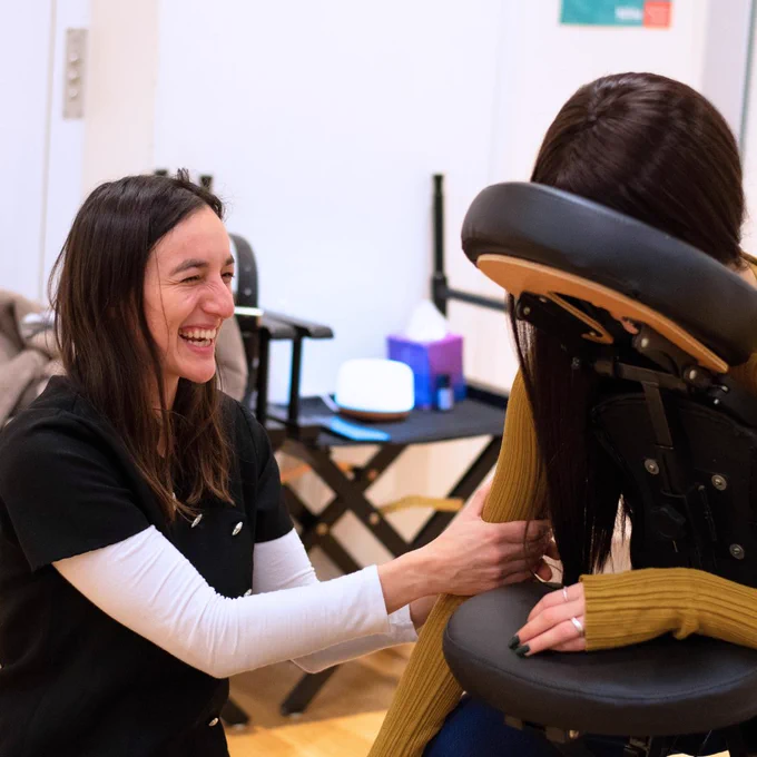 Female massage therapist laughing 
