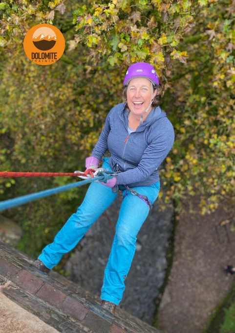A woman abseils off a building. 
