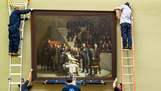 Installation crew mounting Robert C. Hinckley’s painting The First Operation Under Ether at the Lamar Soutter Library