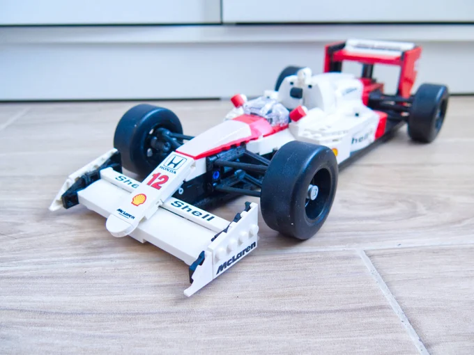 Slightly high angle, front three-quarters shot of a Lego version of a 1988 McLaren MP4/4 Formula One car