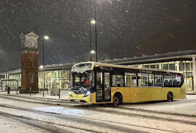 The first yellow Bee Network service pulls out of a snowy Altrincham Interchange in the early hours of this morning.