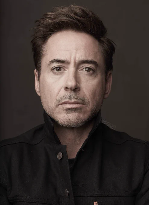 black jacket short brown hair frowning white guy
