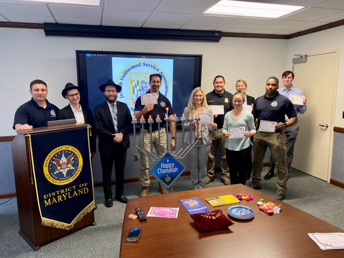 Deputies U.S. Marshals and local law enforcement partners stand with members of the Jewish Uniformed Service Association.