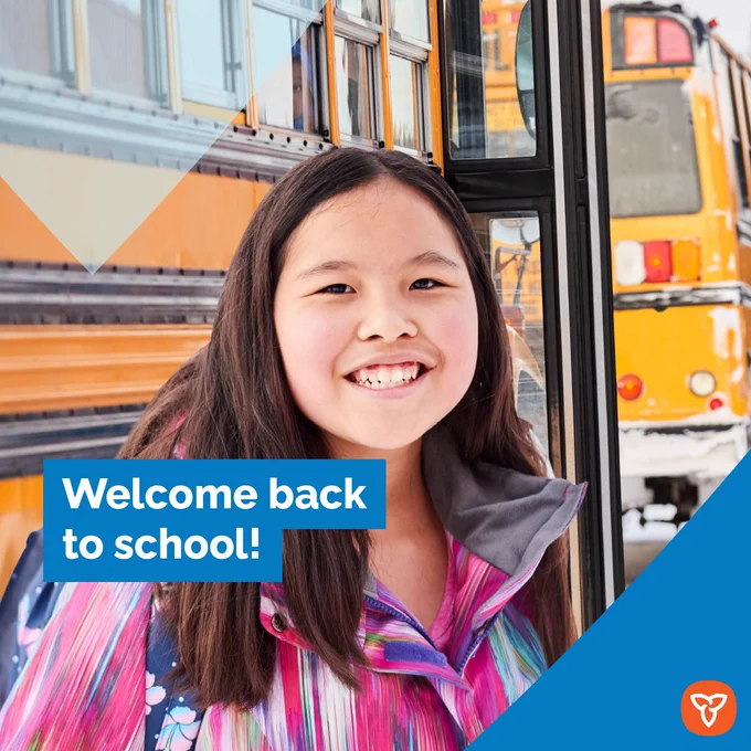Student outside school bus smiling.
Title: Welcome back to school!