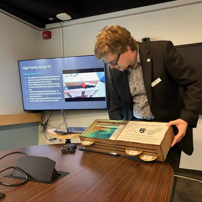 Gordon presents his high fidelity exhibit prototype and demonstrates how portions of the box slide to reveal the geologic history behind Sudbury’s famous impact structure. 