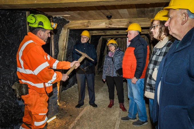 mine guide holding a pickaxe