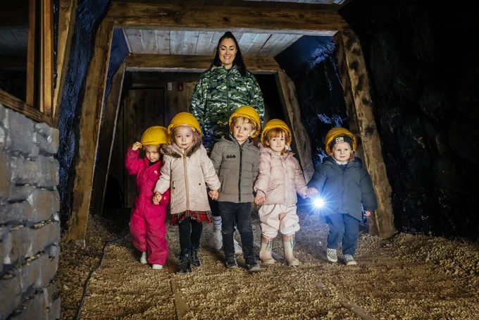 five children walking through the tunnel