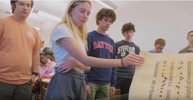 student turn the page of a rare book