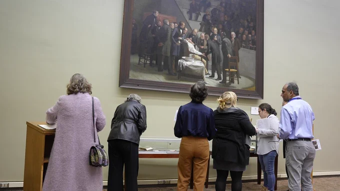 Reception attendees get an up-close look at the painting