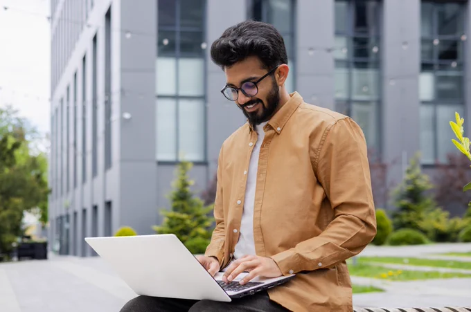 A man looking at his laptop.