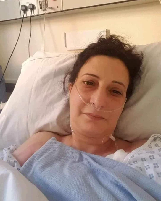 Ameena in a hospital bed and wearing a nasal cannula. 