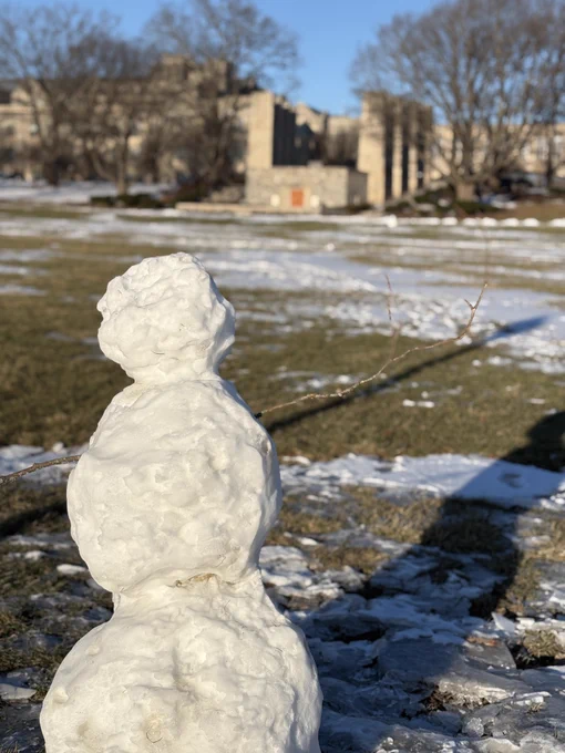 A snowman on the Drillfield with the Pylons in the background.