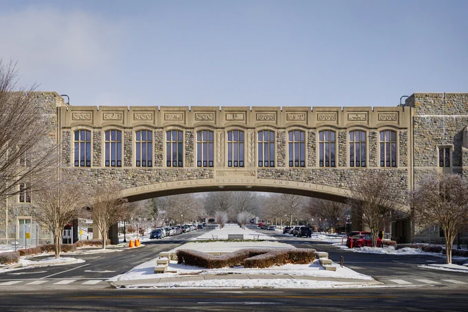 Torgersen Hall Bridge spans over a snow-covered VT shrub