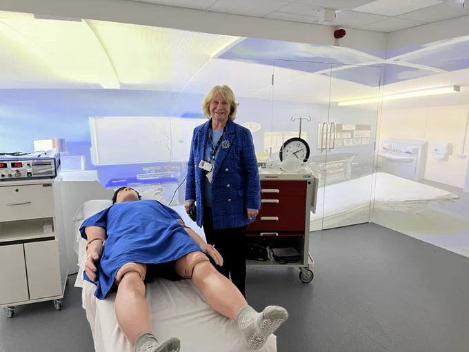 Image shows a governor standing next to an adult male manikin inside the immersive simulation suite.