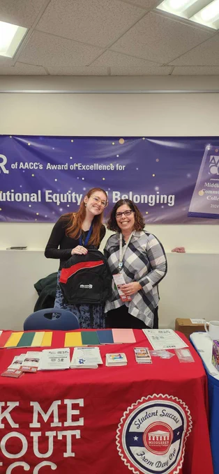 two people pose at booth