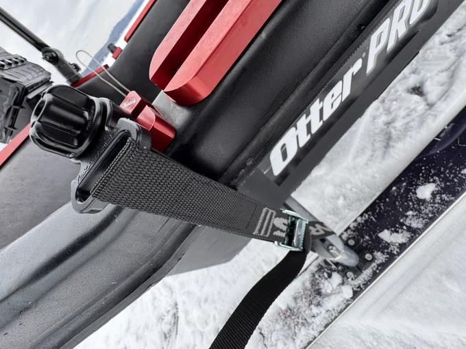Detail of attachment of skis to an ice fishing sled.