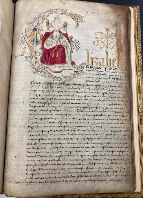 Page within the Plaisterers livery company book of the late 1500s. A page of neat handwritten script dominated by a large illustrated letter E depicting Queen Elizabeth I.
