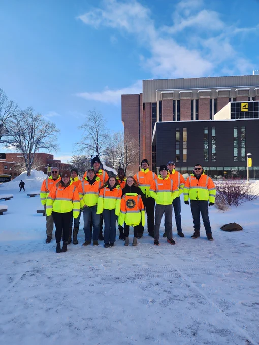 Picture of geospatial students wearing fluorescent coats on the MTU Campus.