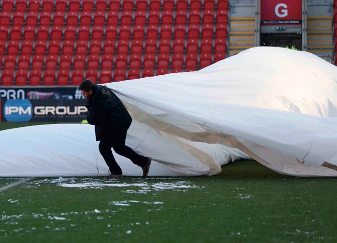 The grounds staff take off the covers and prepare the pitch at AESSEAL New York Stadium.