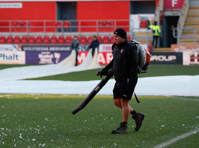 The grounds staff take off the covers and prepare the pitch at AESSEAL New York Stadium.