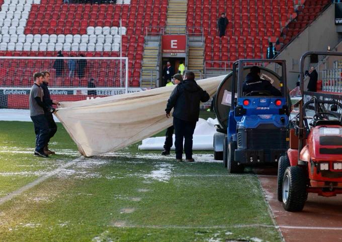 The grounds staff take off the covers and prepare the pitch at AESSEAL New York Stadium.