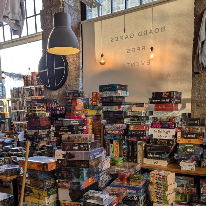 The Edinburgh board game shop Ancient Robot Games during the cleaning process. There are piles of board games by the windows.