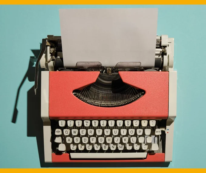 An old fashioned typewriter with a page sticking out of the top of it.