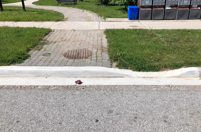 A curb cut that does not align with the path right behind it.