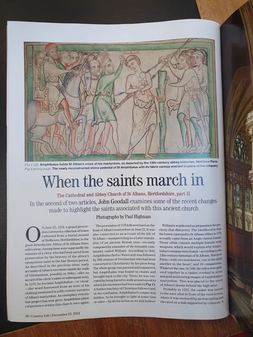 A photo of Country Life magazine featuring an image of medieval manuscript 177 from the Library of Trinity College Dublin. The photo includes an image from the manuscript and the colours are green, red, beige, and blue. The title of the article is: 'When the saints march in'.