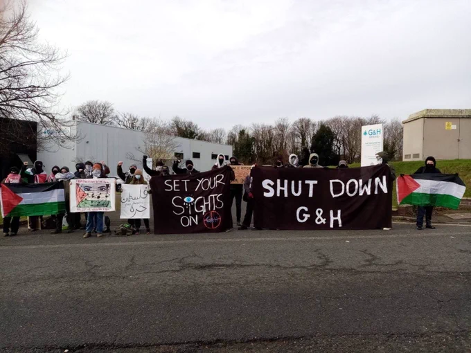 Campaigners blockading G&H in Plymouth with banners reading Shut Down G&H and a Palestinian flag.