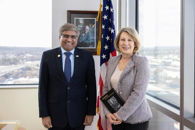 NSF Director and Canada's Chief Science Advisor stand side by side in front of an American flag, posing for a photo.