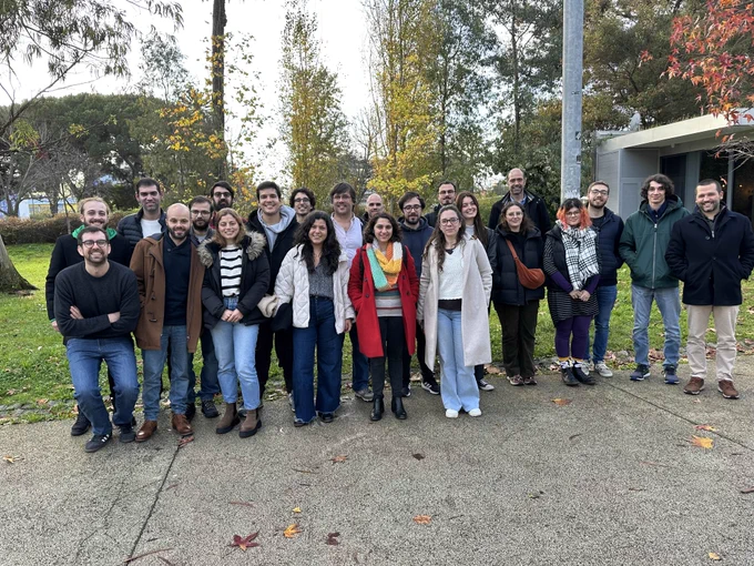 Partial group photo outside the restaurante next to a garden