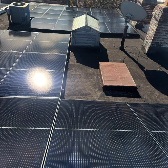 The sun shining on a rooftop solar array.