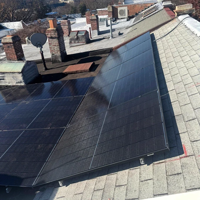 Solar panels on a pitched portion of a flat roof.