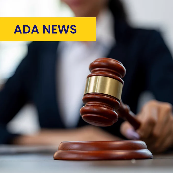 A gavel rests on a wooden base, held by a person in a suit, with the text "ADA News" in bold yellow and blue displayed in the top left corner.
