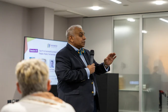 Christian Kumar mediates audience questions for a panel discussion at Venturefest West Midlands 2024.
