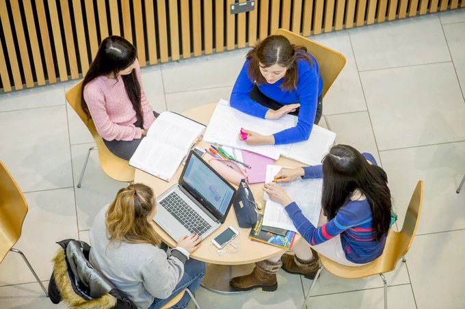Students working on a group table