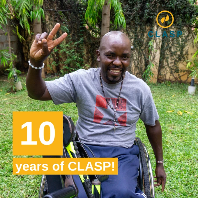 Lazarus in his wheelchair giving the peace sign.