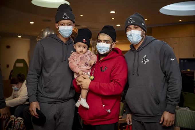 Kristian Campbell and Carlos Narváez pose with a patient at The Jimmy Fund.