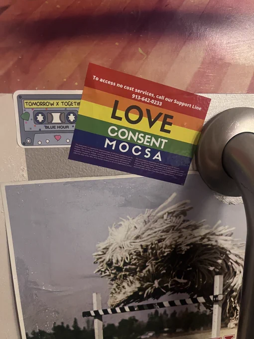 Rainbow sticker on a wall at Skyline Salon in Kansas City that reads Love Consent MOCSA in white text.