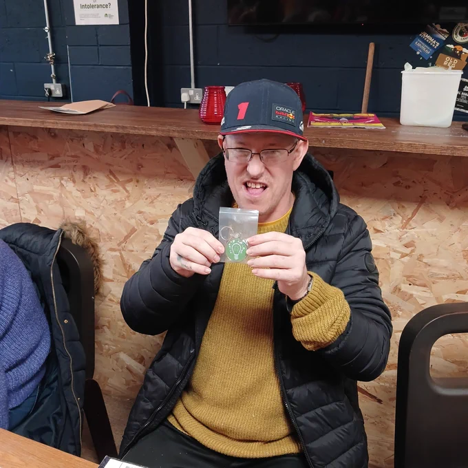Holding up  a green energy's  saving keyring
