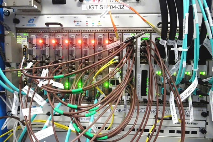 The CMS Phase-1 Level-1 Trigger system, a machine with red lights and a lot of wires coming out of it.